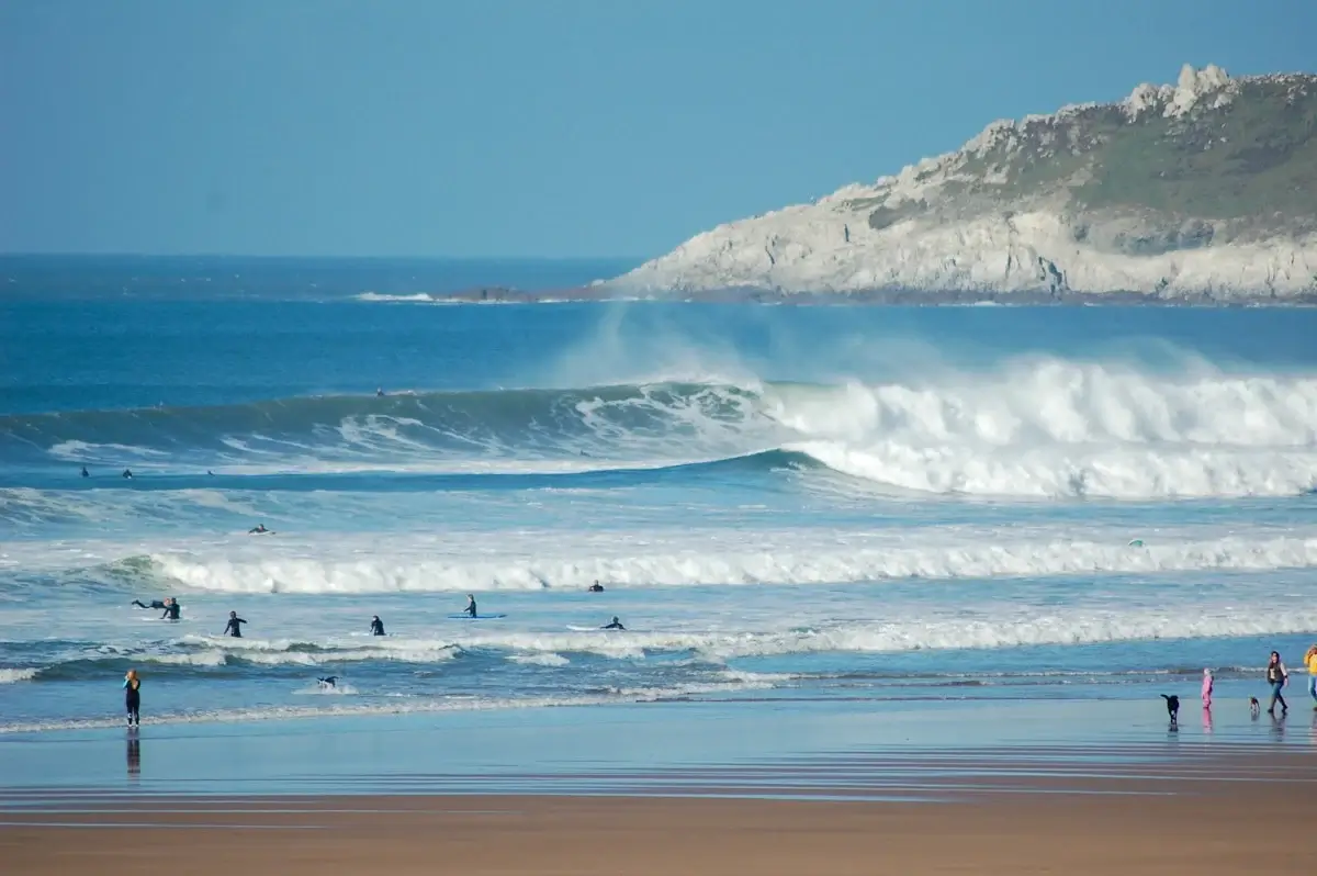 Panoramic view of a Devon coastline with golden bay and cliffs